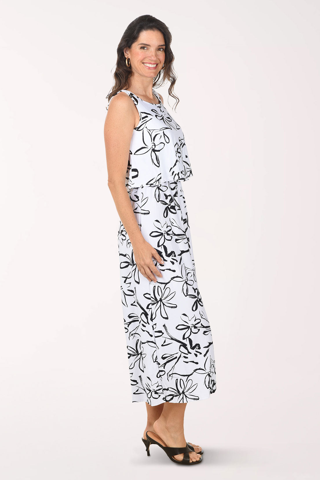 Woman wearing a black and white floral dress on a white background
