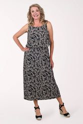 Woman wearing a black and white patterned dress on a white background