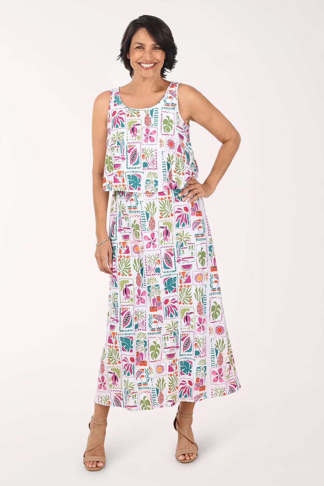 Woman wearing a colorful patterned dress on a white background