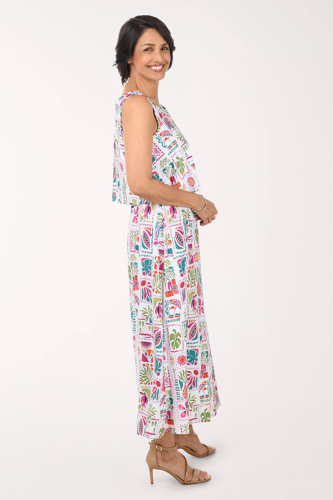 Woman wearing a colorful patterned dress on a white background