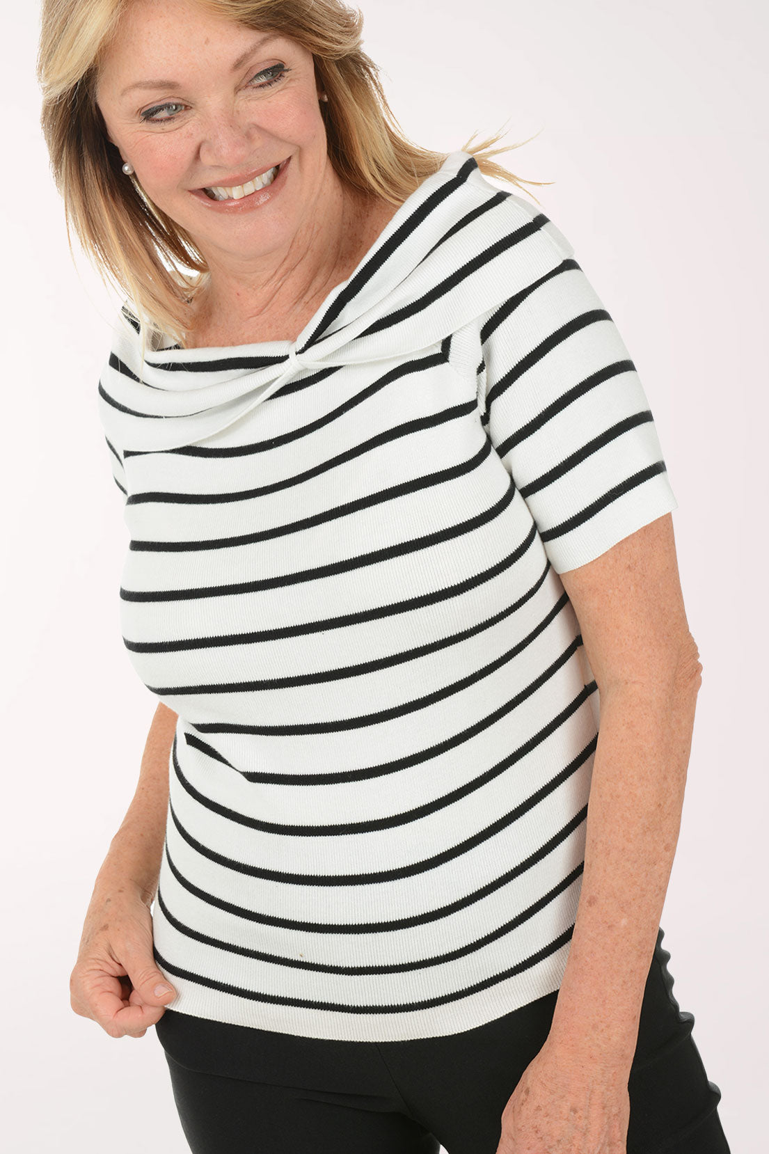 Woman wearing a black and white striped shirt against a white background