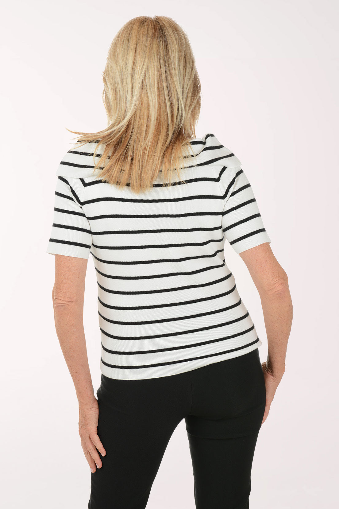 Woman wearing a black and white striped shirt against a white background