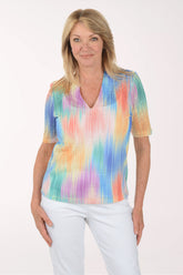 Woman wearing a colorful tie-dye shirt on a white background