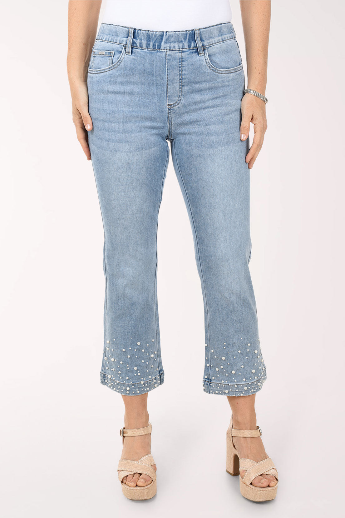 Light blue jeans worn by a person on a white background