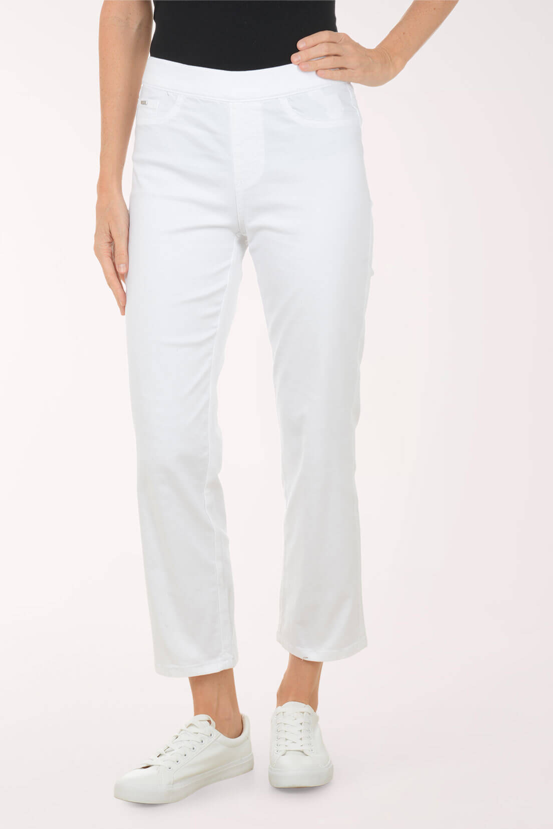 Person wearing white pants on a plain background