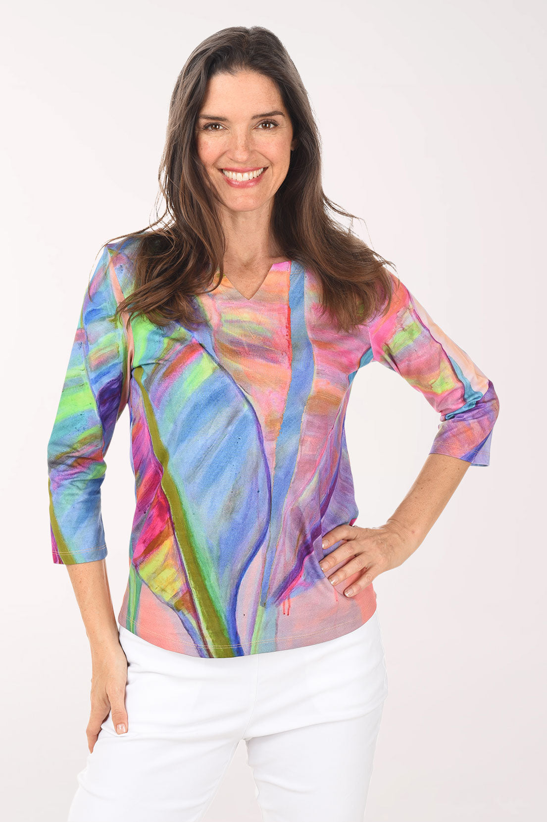 Woman wearing a colorful abstract patterned top on a white background