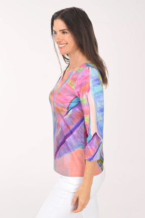 Woman wearing a colorful abstract patterned top on a white background