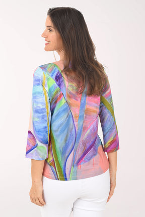 Woman wearing a colorful abstract patterned top on a white background
