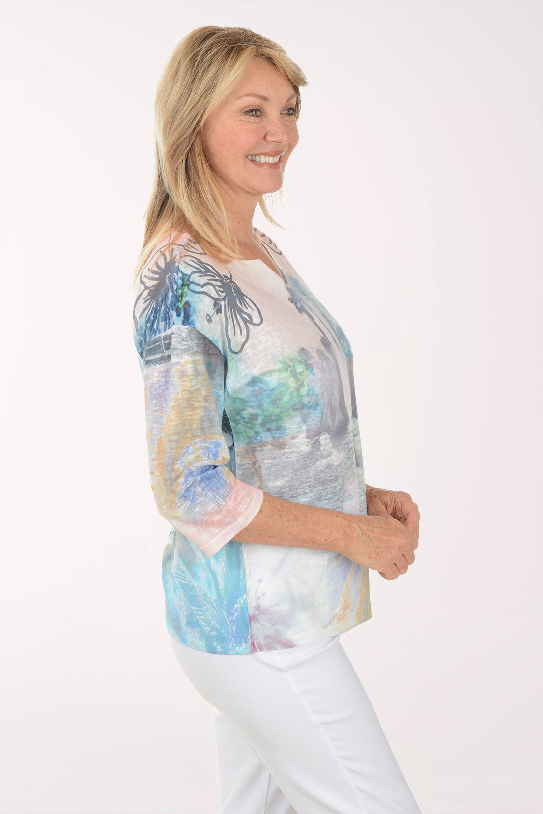 Woman wearing a colorful blouse with a white background