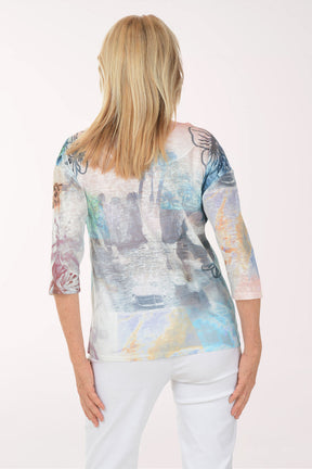 Woman wearing a colorful blouse with a white background