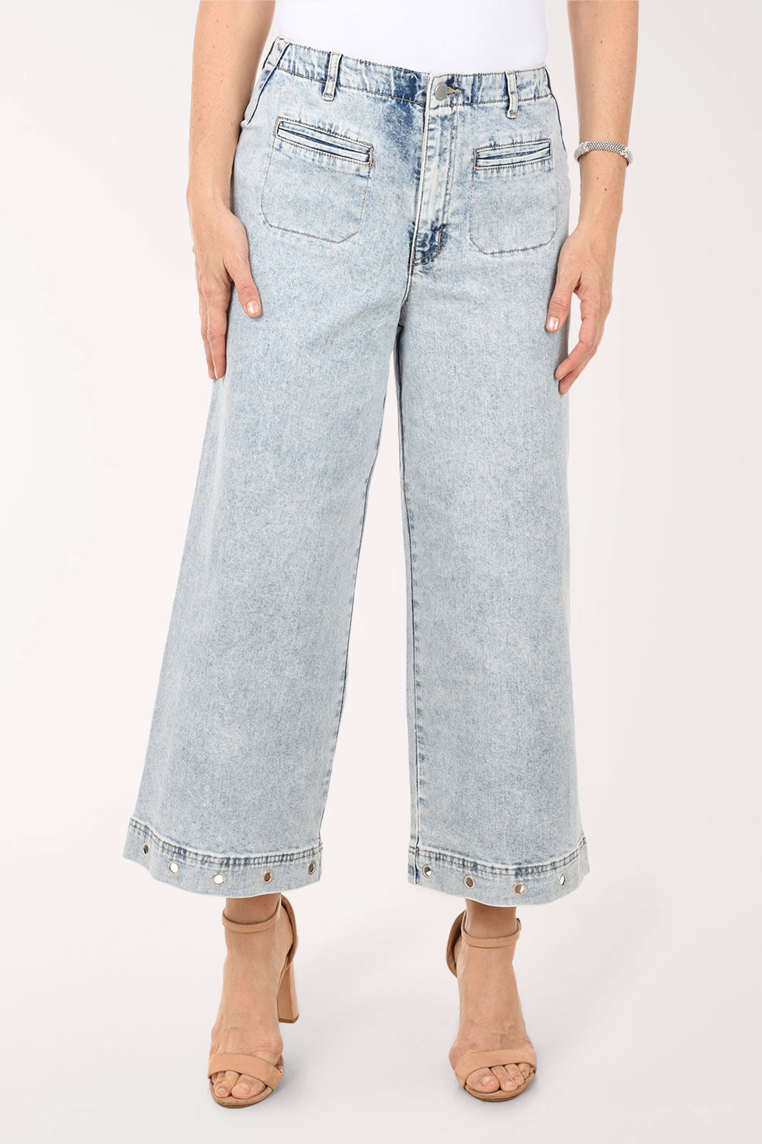 Light blue jeans worn by a person on a white background