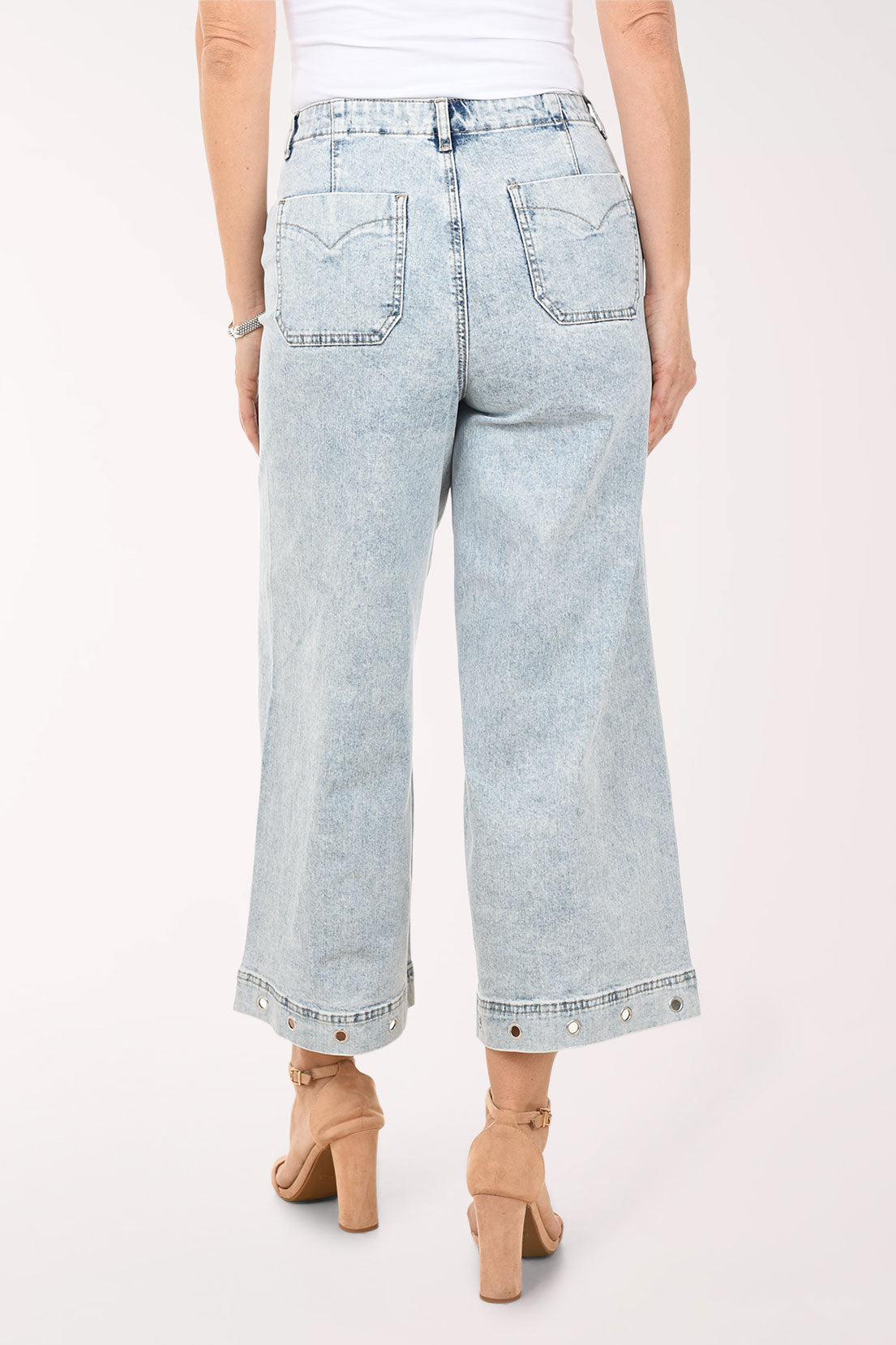 Light blue jeans worn by a person on a white background