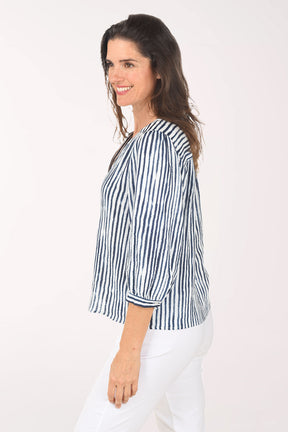 Woman wearing a blue and white striped shirt on a white background