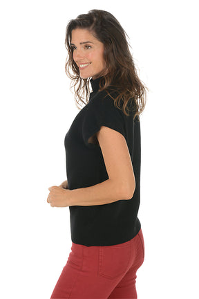 Woman wearing a black sleeveless top and red pants on a white background. Side shot.