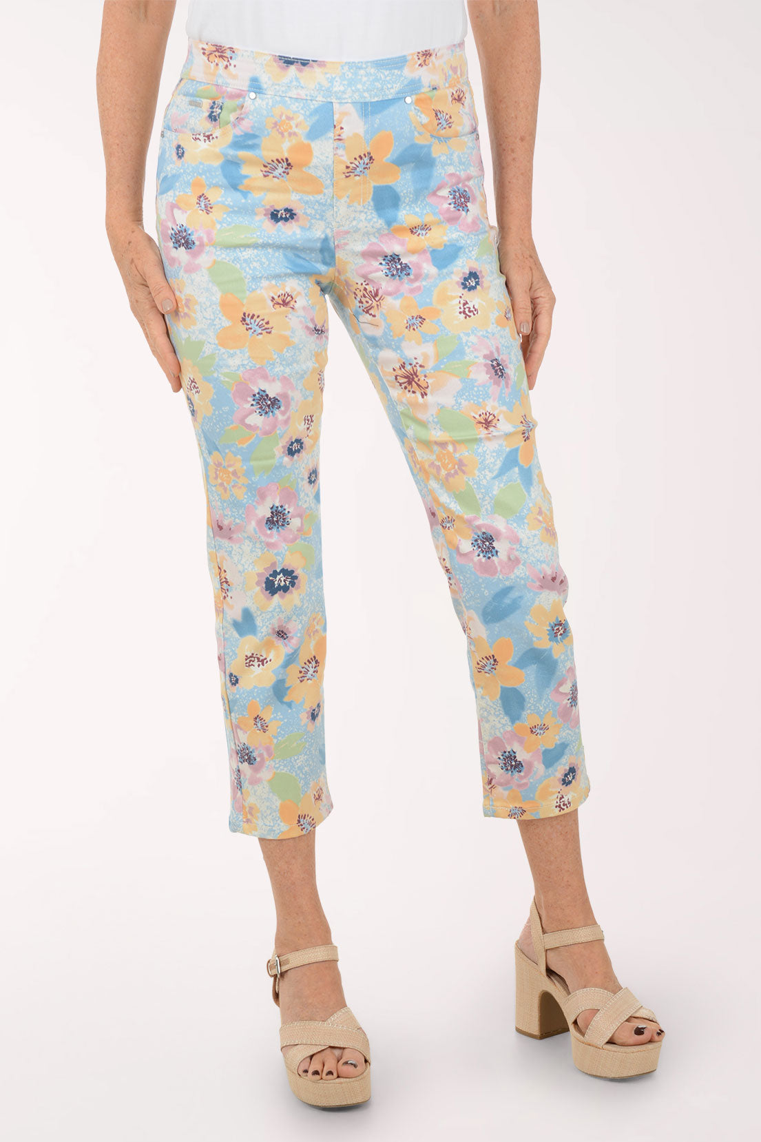 Floral-patterned pants worn by a person on a white background