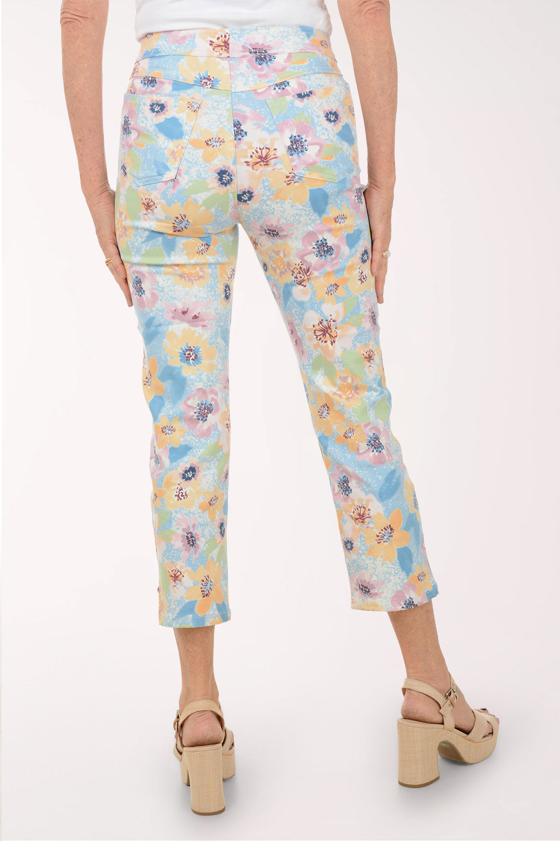 Floral-patterned pants worn by a person on a white background