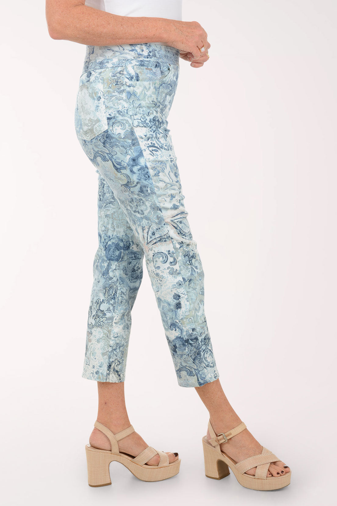 Person wearing blue patterned pants on a white background