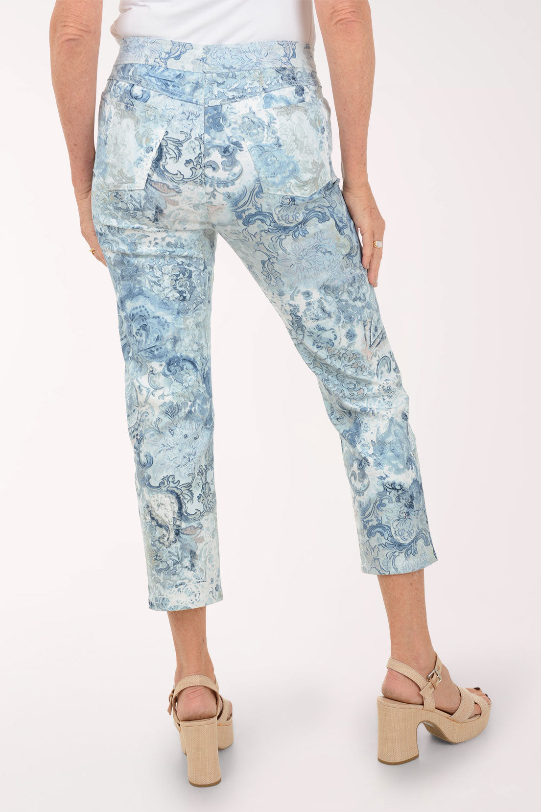 Person wearing blue patterned pants on a white background