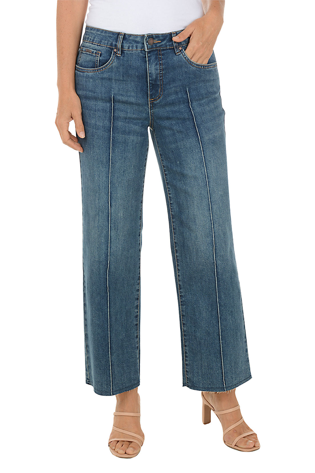Person wearing blue cropped jeans on a white background.