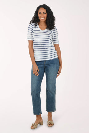Woman wearing a striped shirt and jeans on a white background