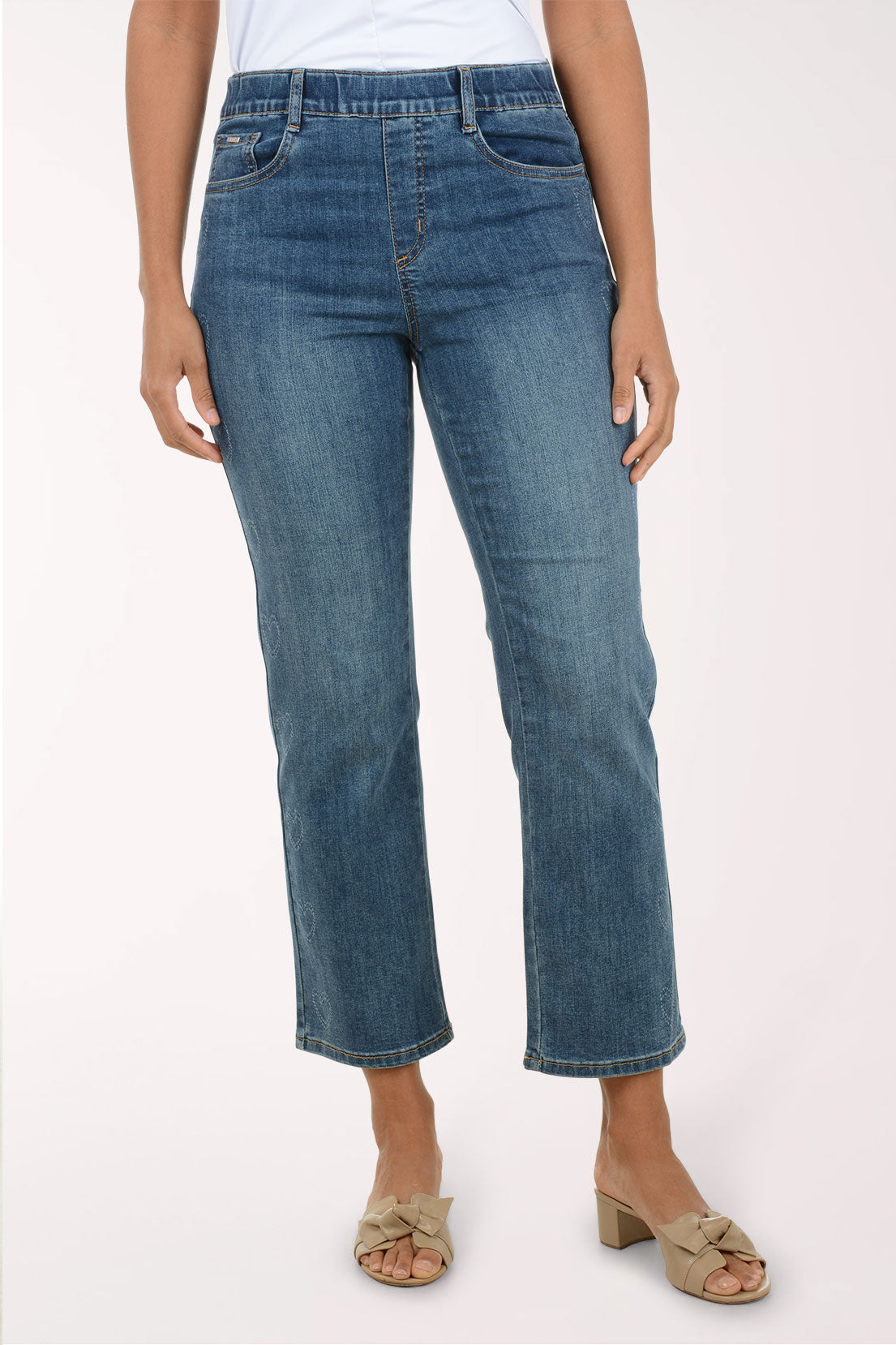 Person wearing blue jeans on a white background