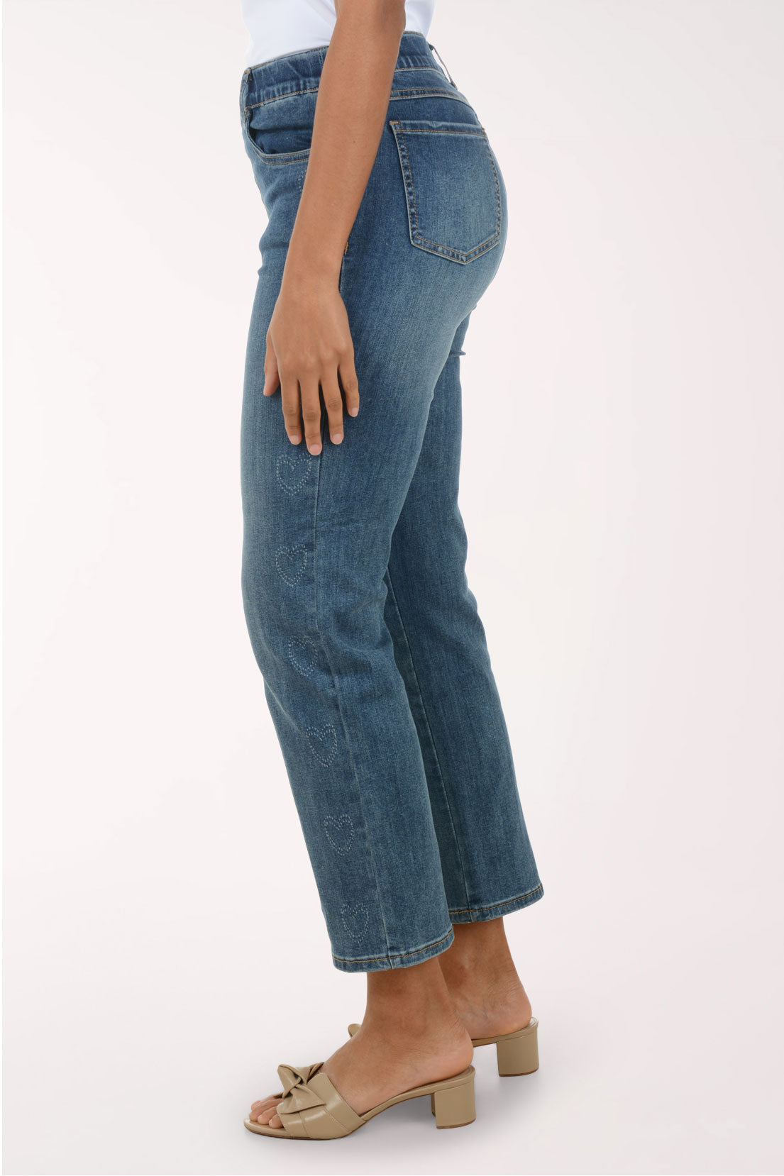 Person wearing blue jeans on a white background