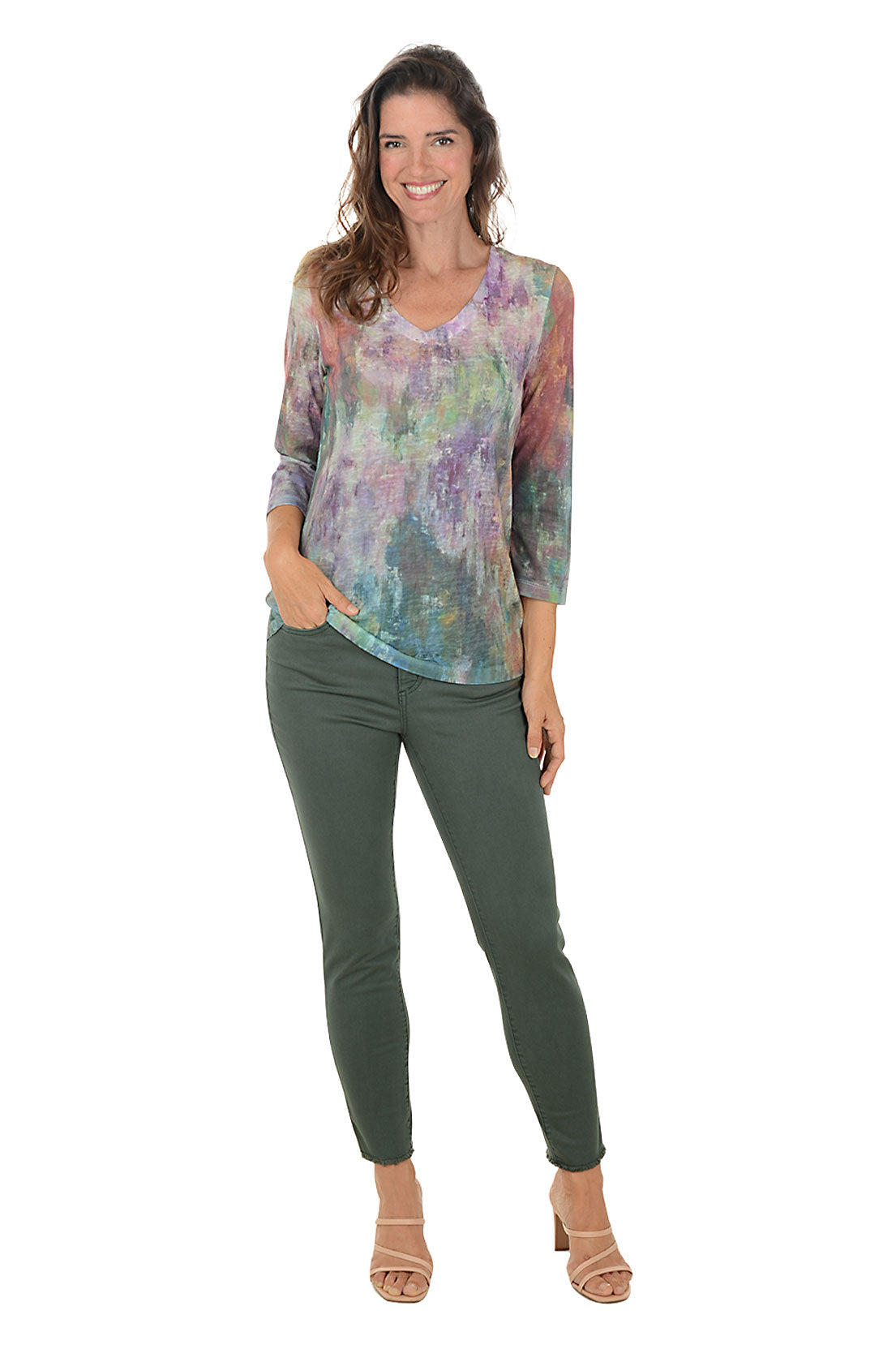 Person wearing green ankle jeans on a white background. Full length shot.