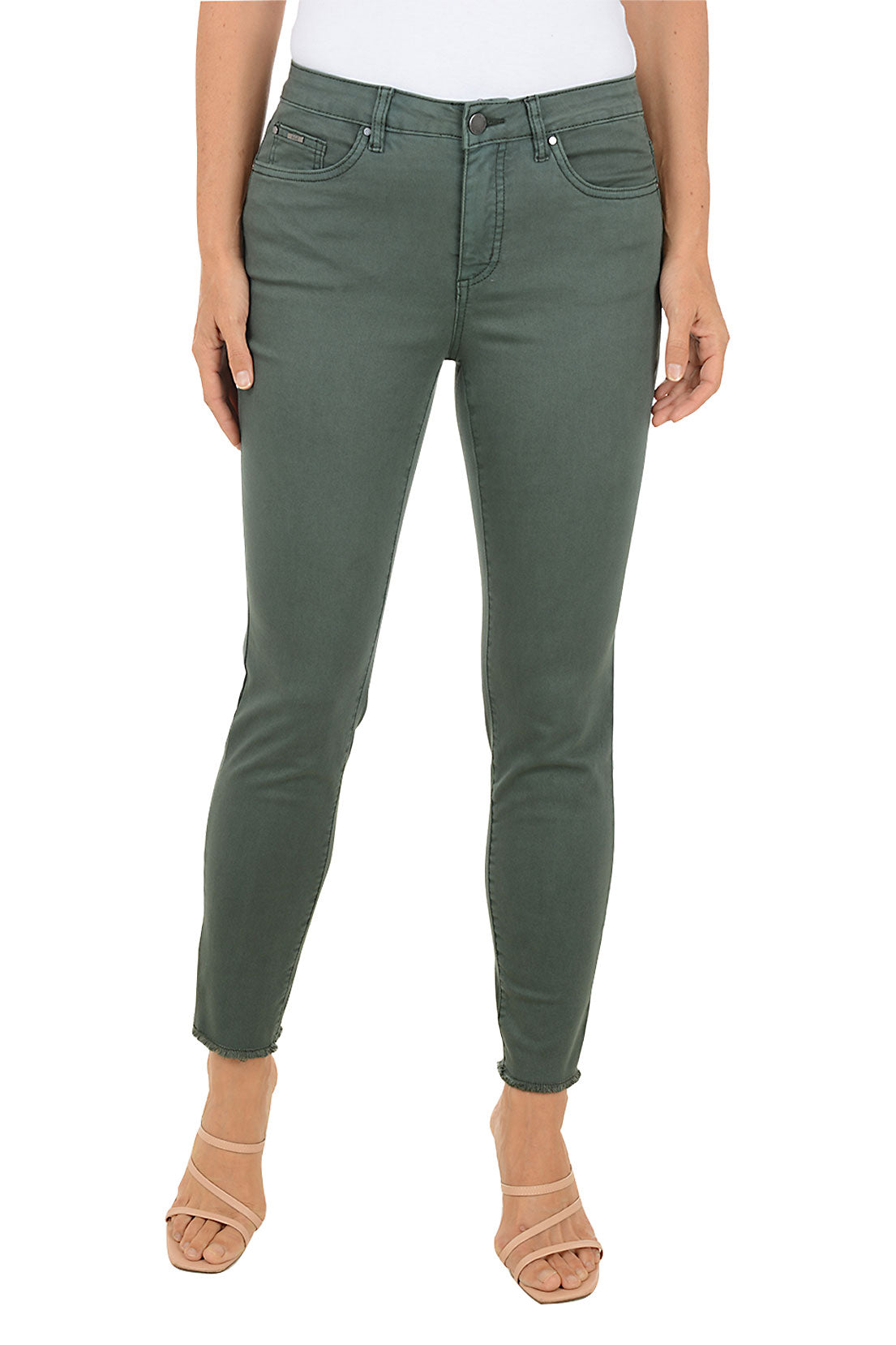 Person wearing green ankle jeans on a white background.