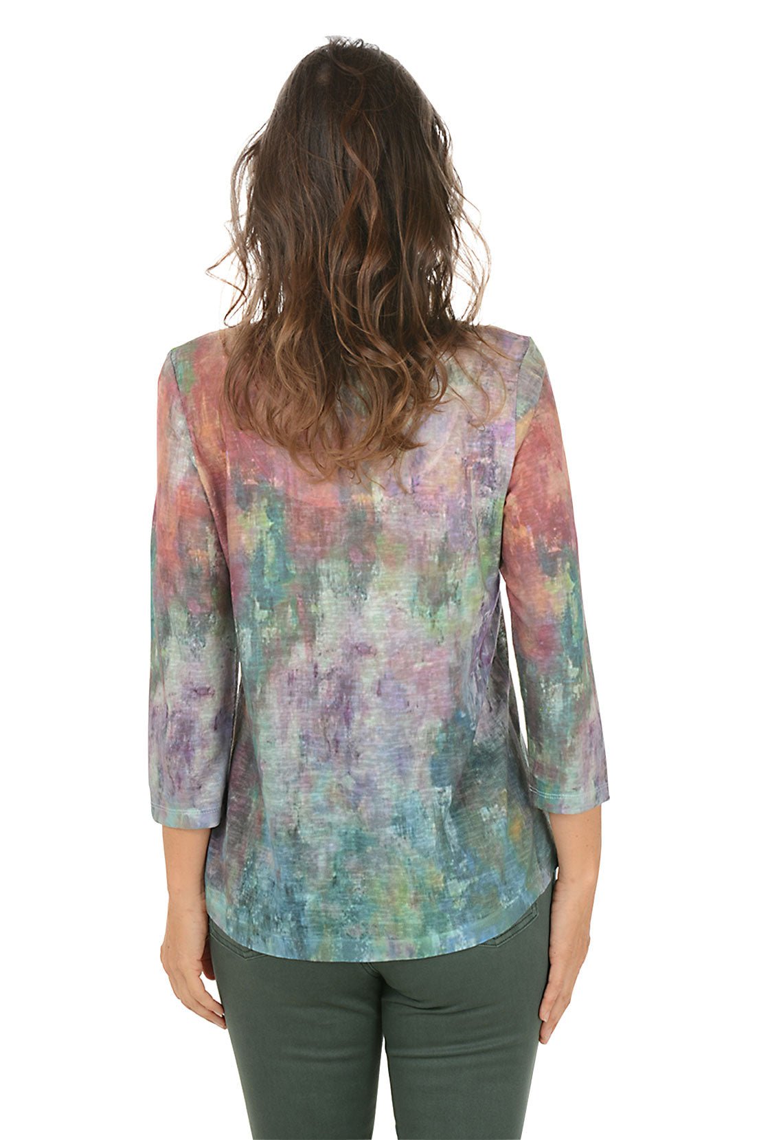 Woman wearing a v-neck 3/4 sleeve colorful tie-dye shirt and green pants on a white background. Back shot.