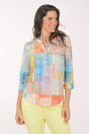 A woman wearing a multicolored plaid 3/4 sleeve top.
