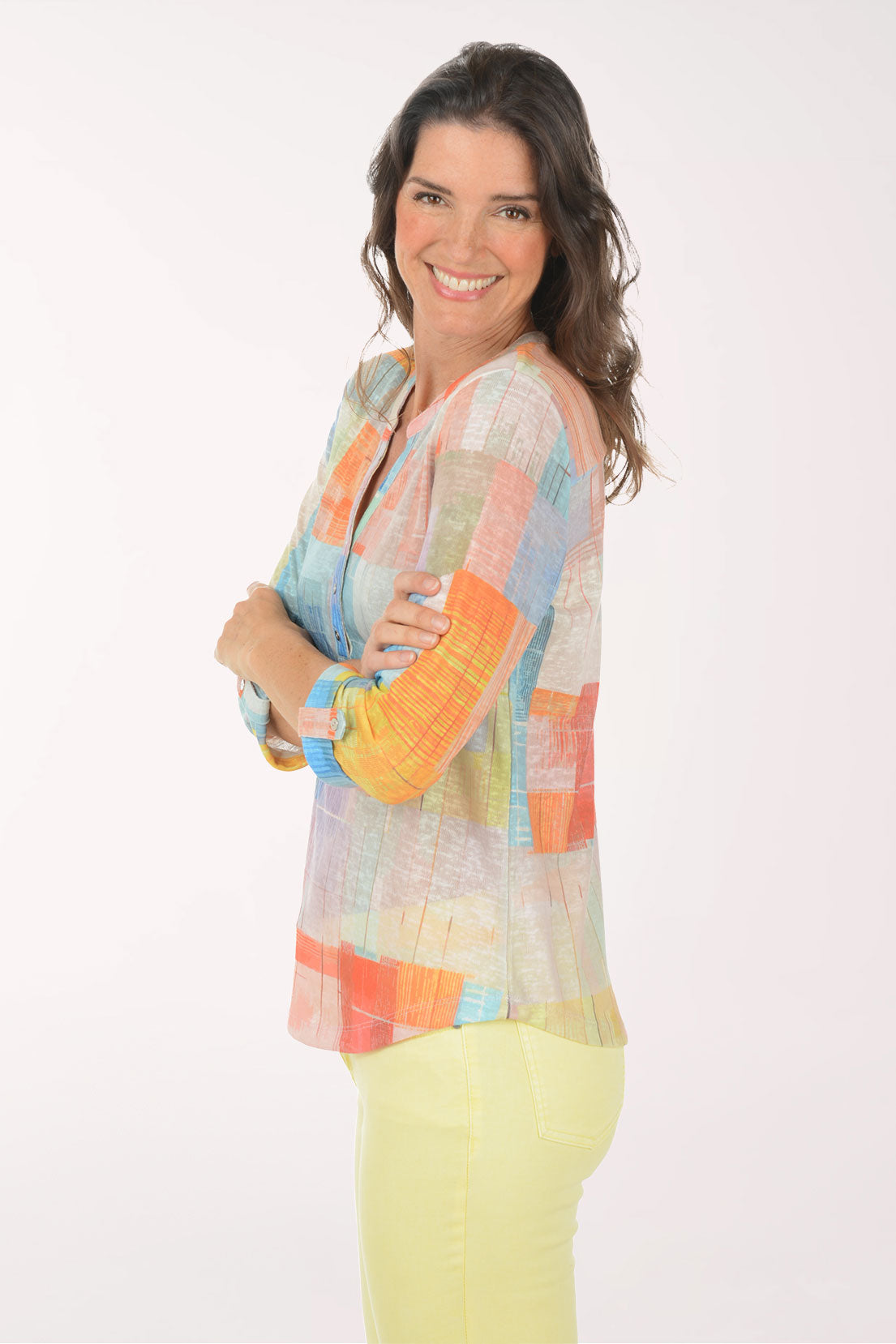 A woman wearing a multicolored plaid 3/4 sleeve top.