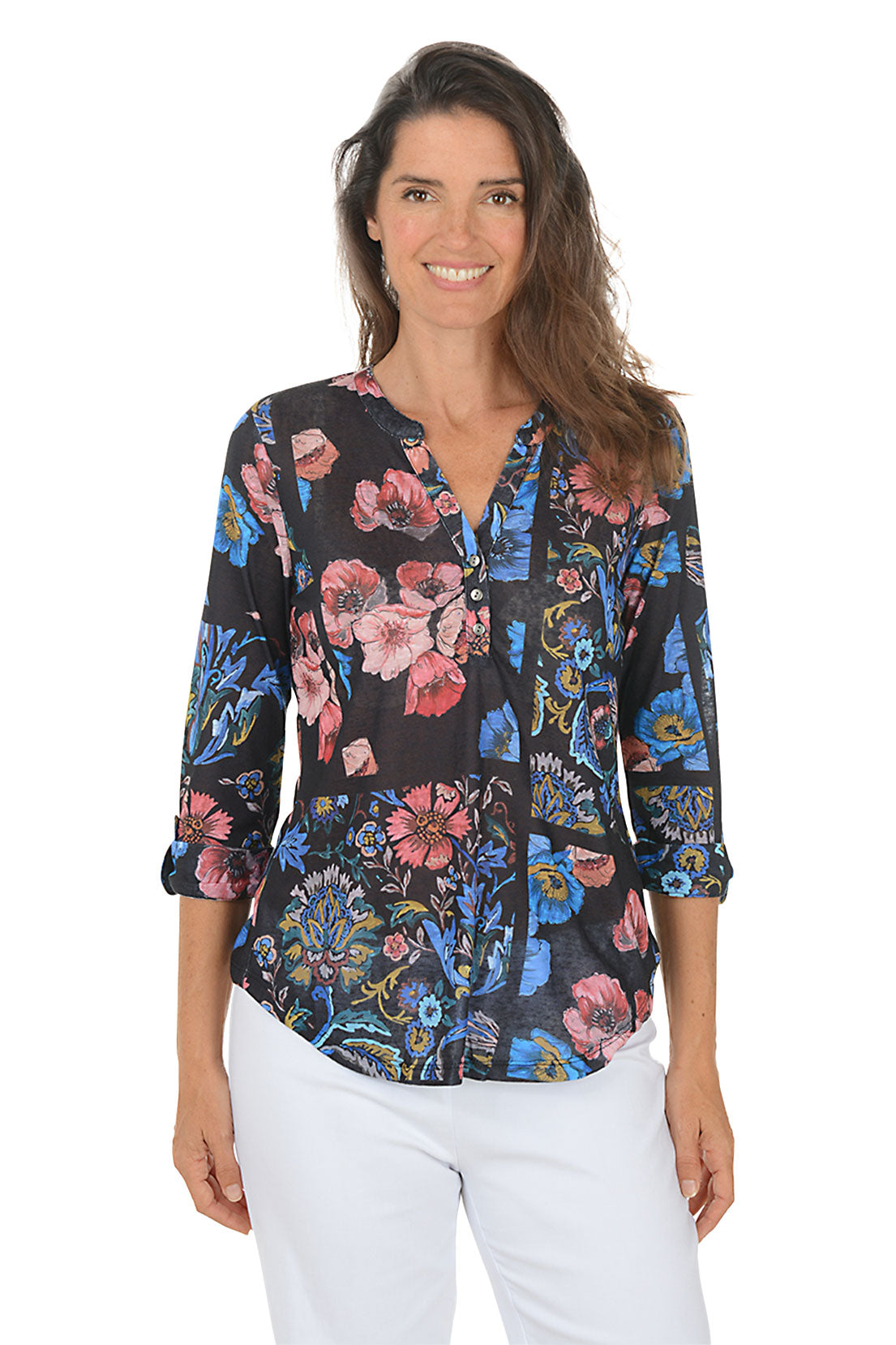 Woman wearing a 3/4 sleeve floral blouse with a v-neck neckline with a white background.