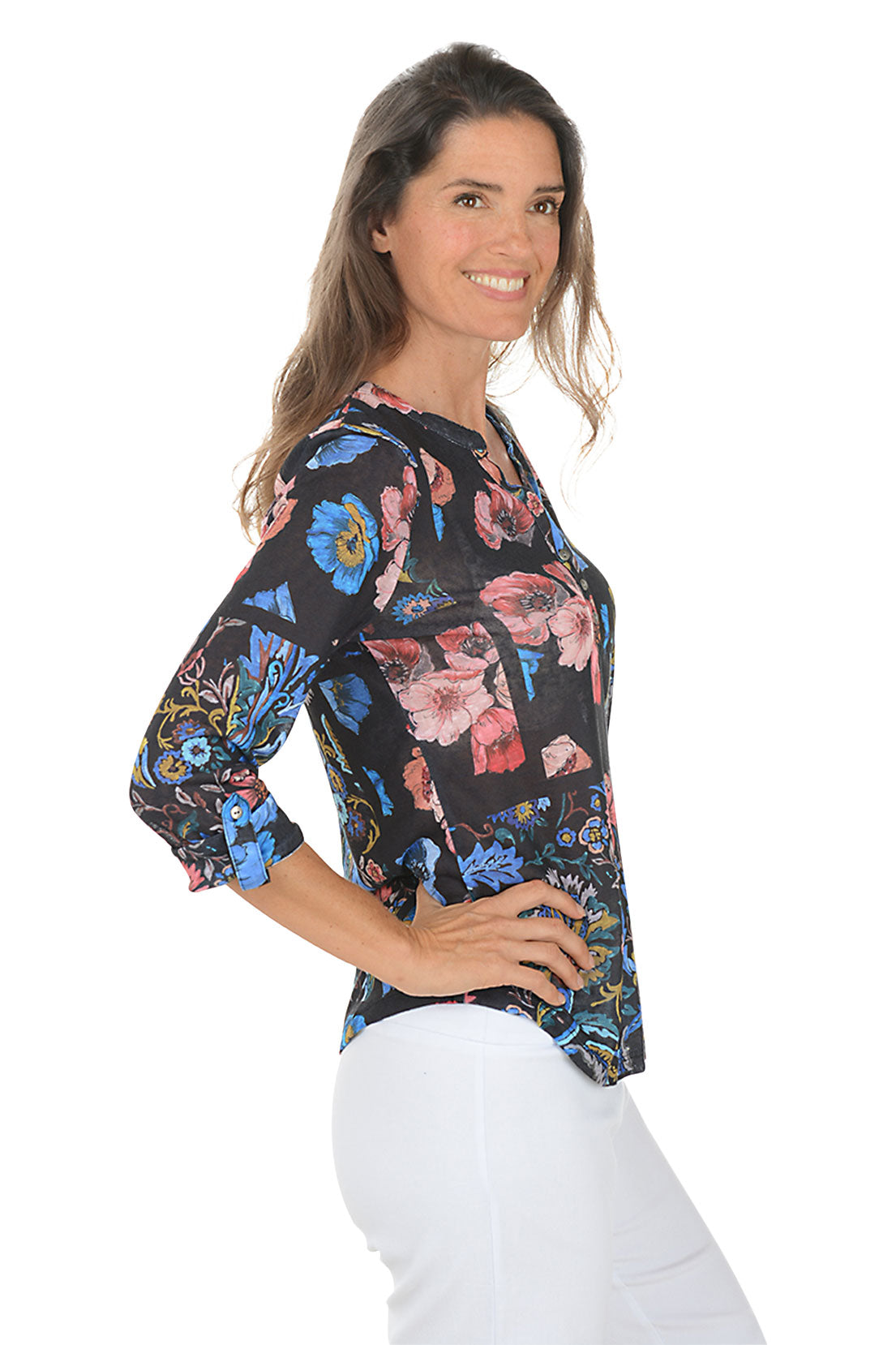 Woman wearing a 3/4 sleeve floral blouse with a v-neck neckline with a white background. Side shot.