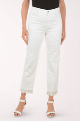 Person wearing white jeans with lace trim on a white background