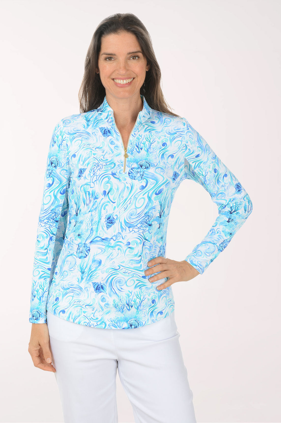 Woman wearing a blue floral long-sleeve shirt on a white background