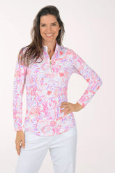 Woman wearing a colorful long-sleeve shirt with a white background