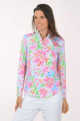 Woman wearing a colorful floral long-sleeve shirt on a white background