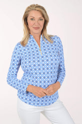 Woman wearing a blue floral patterned shirt on a white background