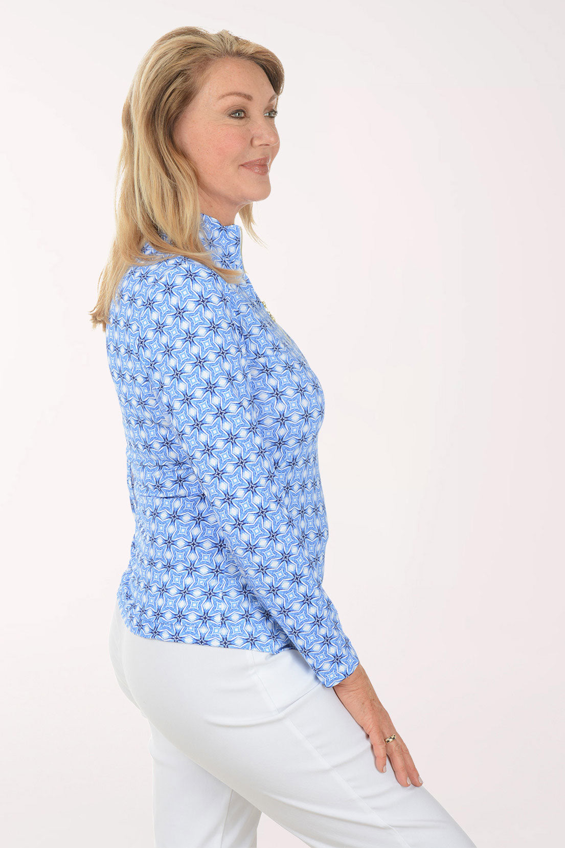 Woman wearing a blue floral patterned shirt on a white background