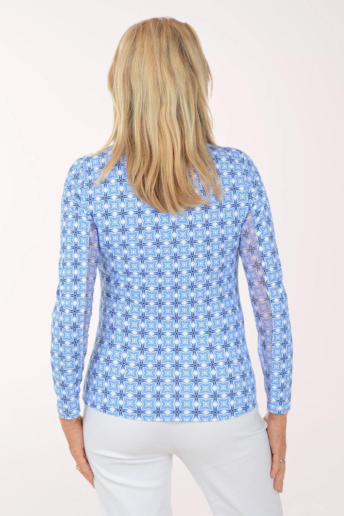 Woman wearing a blue floral patterned shirt on a white background