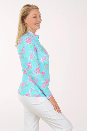 Woman wearing a colorful floral patterned shirt on a white background