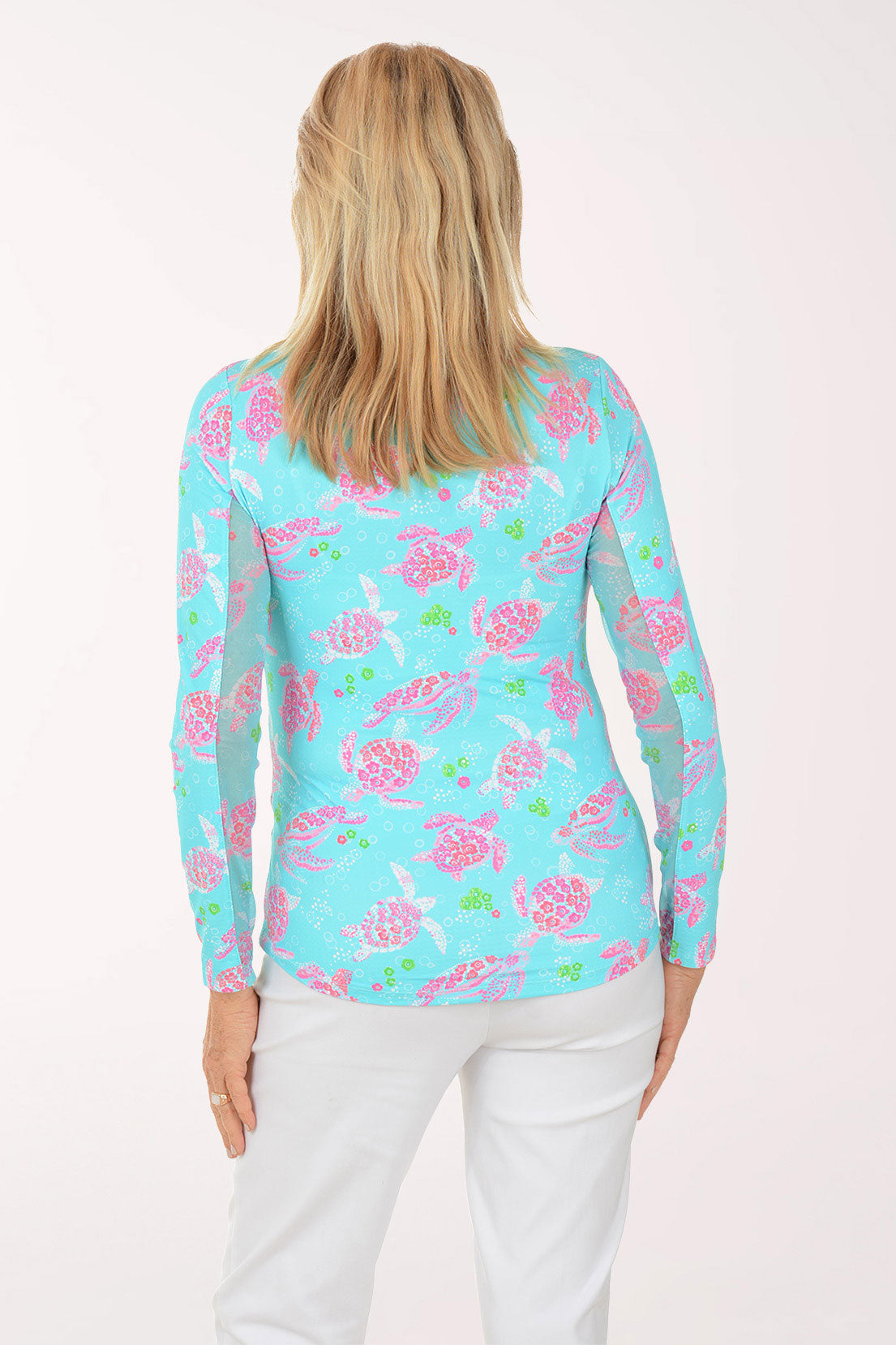 Woman wearing a colorful floral patterned shirt on a white background