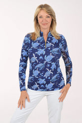 Woman wearing a blue turtle patterned shirt on a white background