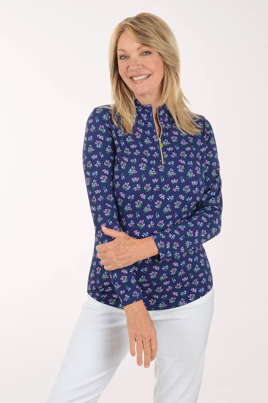 Woman wearing a floral patterned shirt on a white background