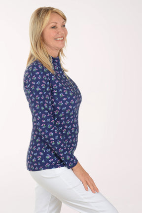 Woman wearing a floral patterned shirt on a white background
