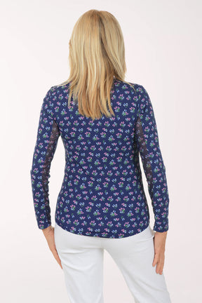 Woman wearing a floral patterned shirt on a white background