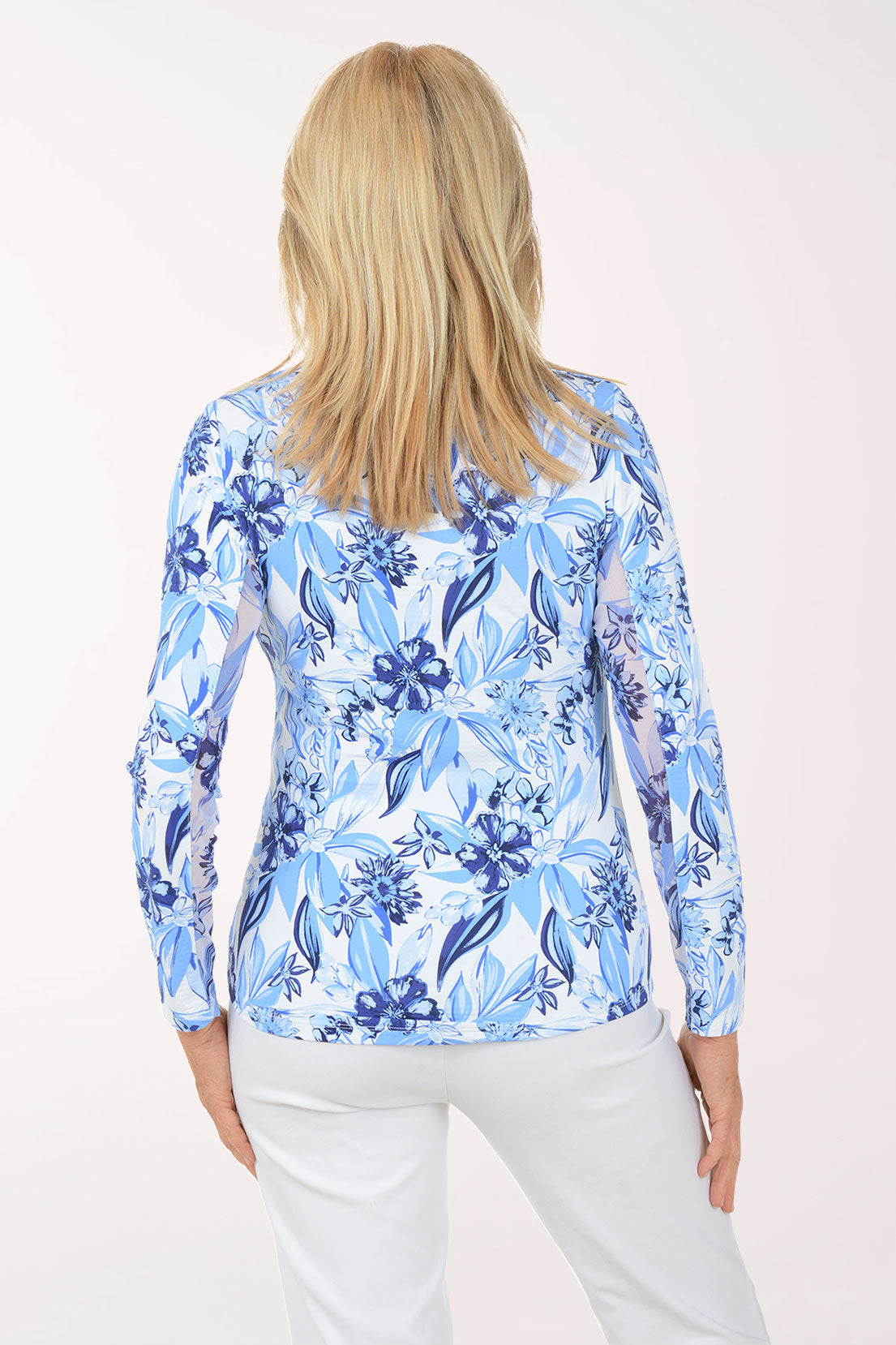 Woman wearing a blue floral patterned shirt on a white background