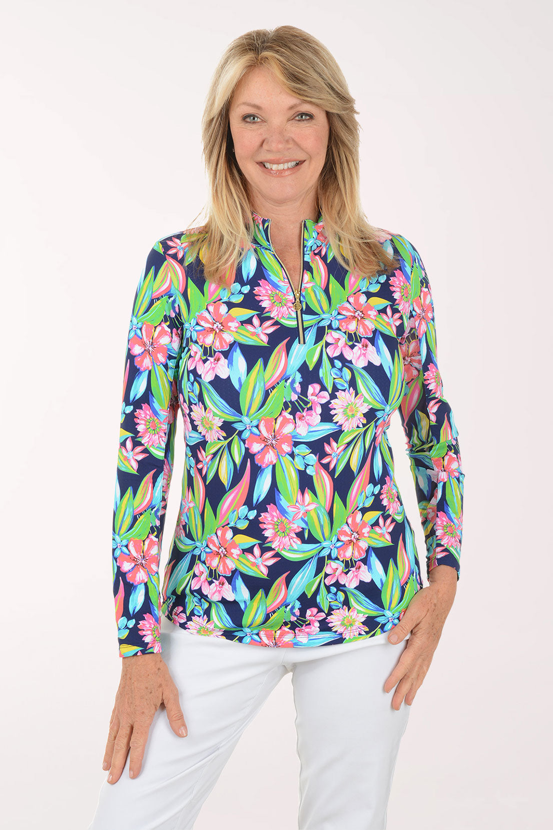 Woman wearing a colorful floral long-sleeve top on a white background