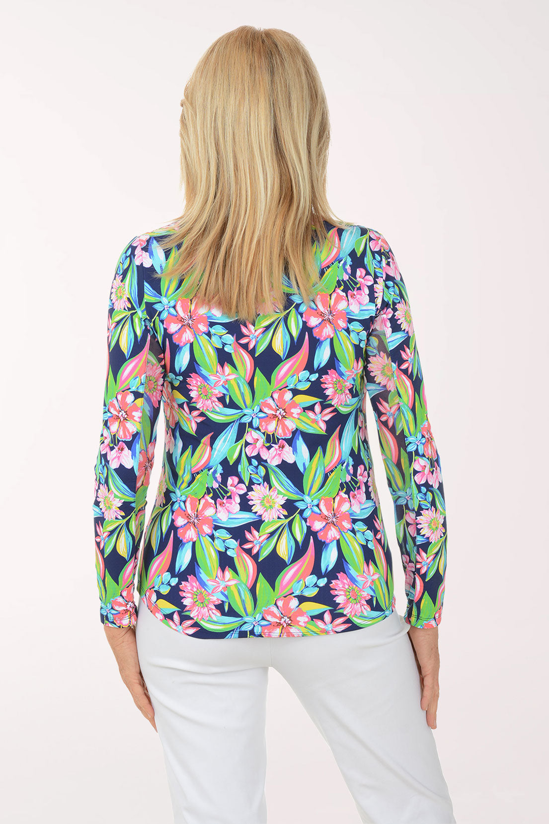 Woman wearing a colorful floral long-sleeve top on a white background