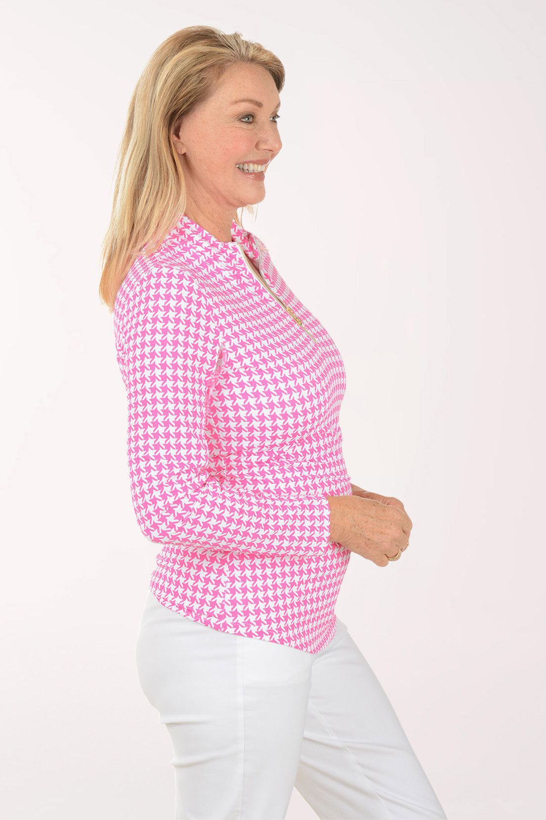 Woman wearing a pink checkered shirt against a white background